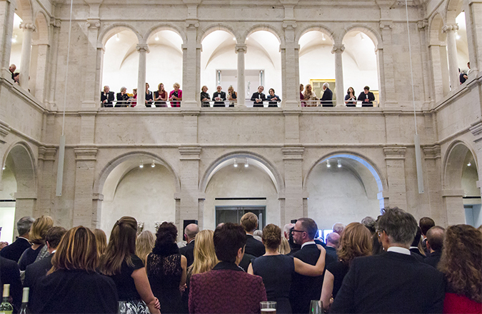 A crowd of people gather in the courtyard and arcades of the Harvard Art Museums.