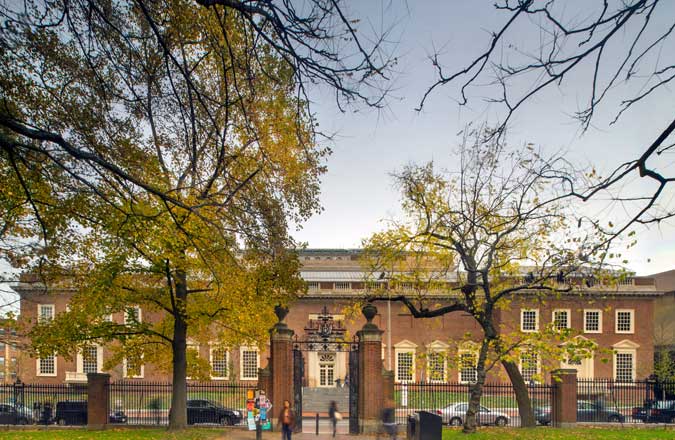 A springtime view of the Harvard Art Museums red brick facade on Quincy Street from within Harvard Yard.